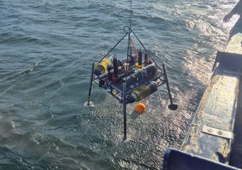A lander with diverse sensors is lowered into the Baltic Sea from aboard a research vessel to carry out measurements at the seafloor.